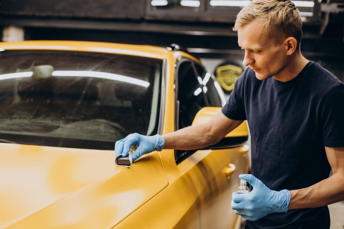 man-at-car-service-doing-car-ceramic-procedure
